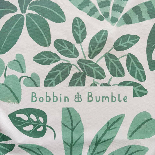 Splashmat with green leaf pattern and 'Bobbin & Bumble' branding on a white background