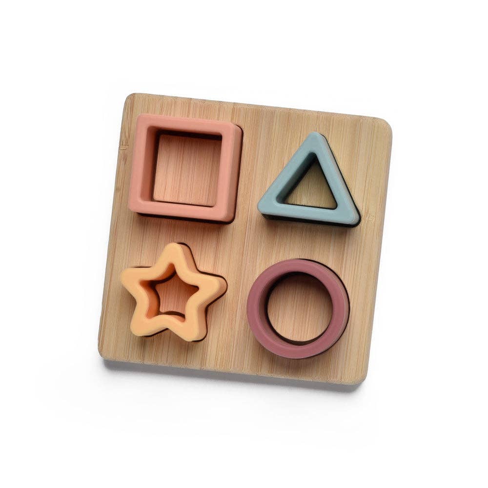 Wooden shape sorting toy with square, triangle, star, and circle shapes on a wooden board.