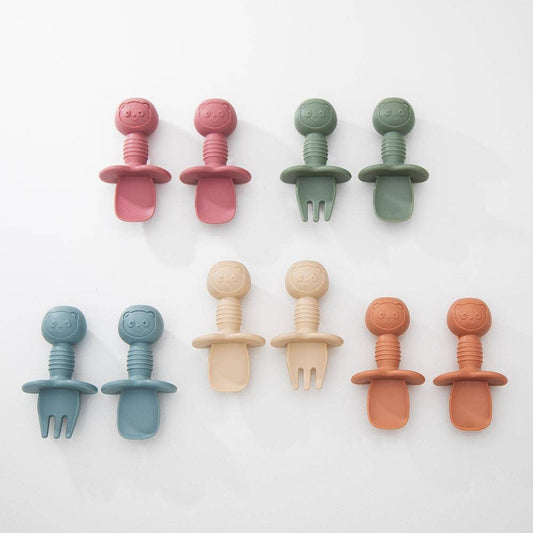 Set of colorful baby teething toys on a white background