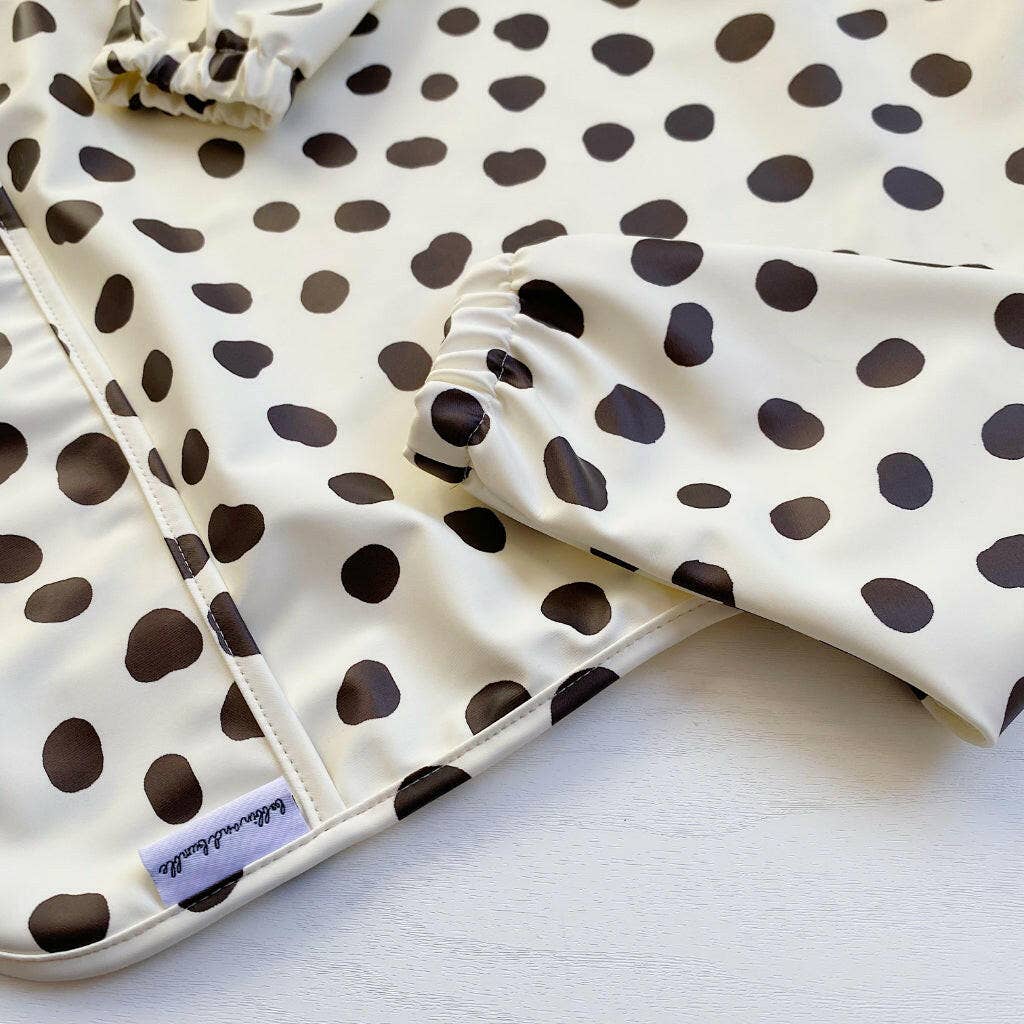 White bib with black polka dots on a white background