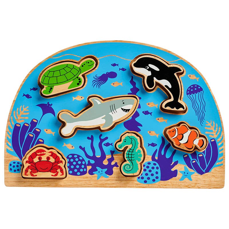 Wooden puzzle with sea animal figures on a blue background
