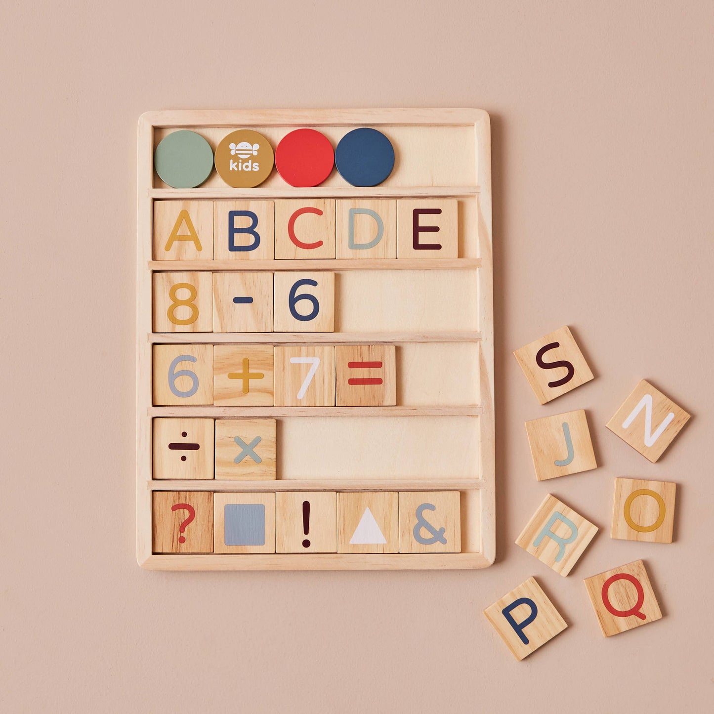 Wooden educational toy with letters, numbers, and symbols on a beige background