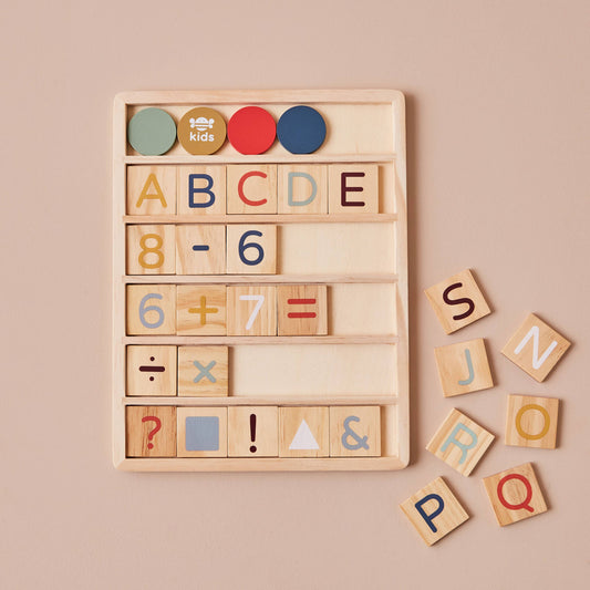 Wooden educational toy with letters, numbers, and symbols on a beige background