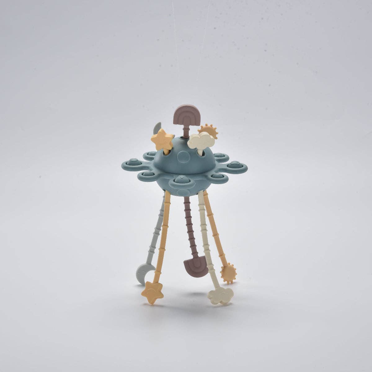 Children's toy with a blue base and various shapes on a light grey background