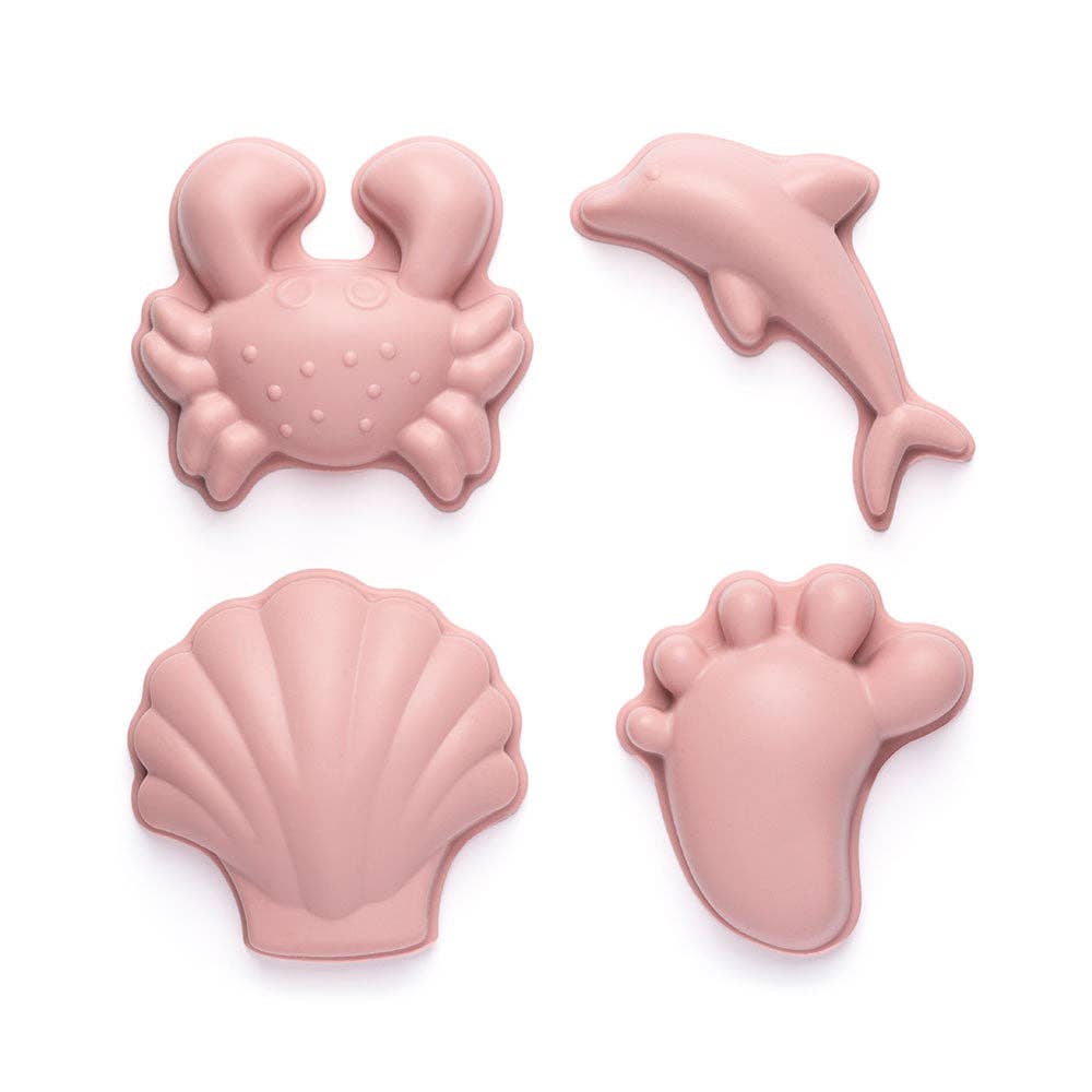Set of pink silicone sand toys shaped like a crab, dolphin, shell, and footprint on a white background.