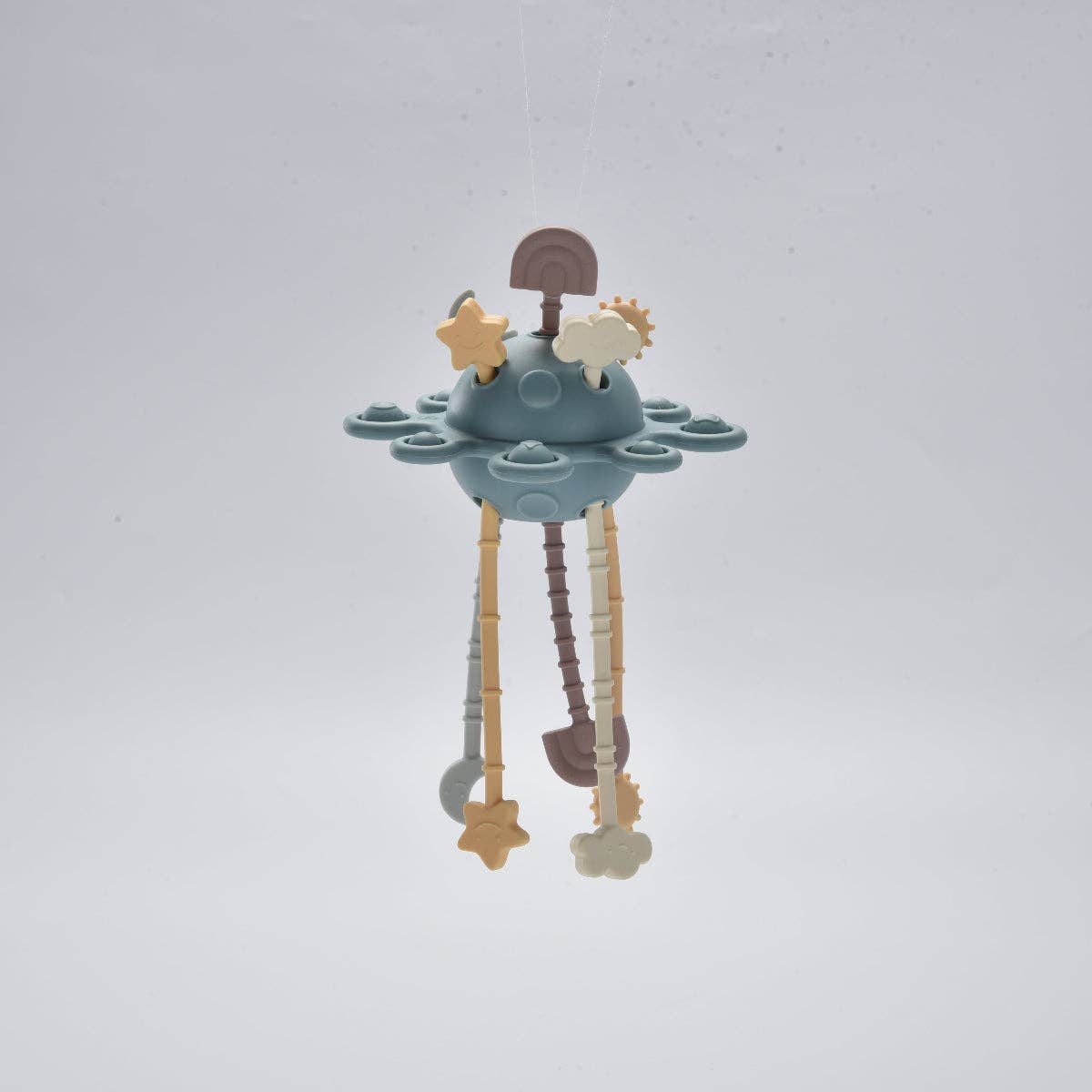 Children's teething toy with stars and clouds on a light grey background