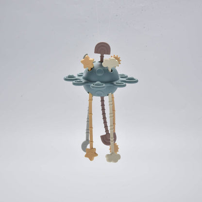 Children's teething toy with stars and clouds on a light grey background