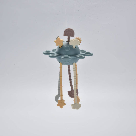 Children's teething toy with stars and clouds on a light grey background