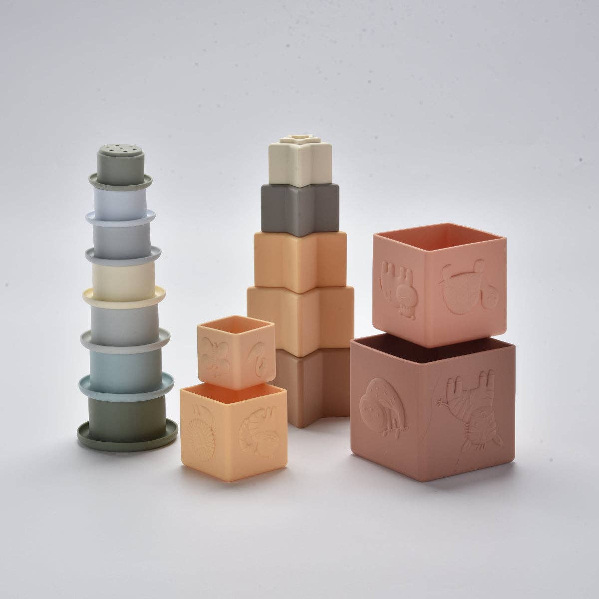 Set of silicone building blocks with embossed designs on a light grey background
