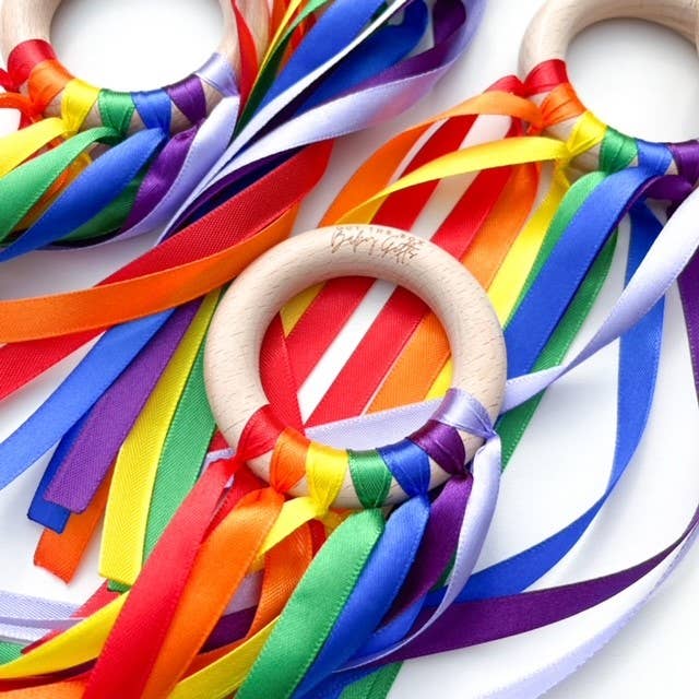 Wooden rings with colorful ribbons on a white background