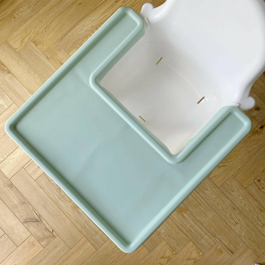 Light green silicone mat on white Ikea highchair