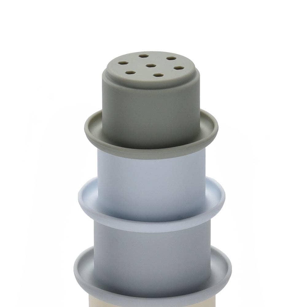 Grey silicone stacking cups on a white background
