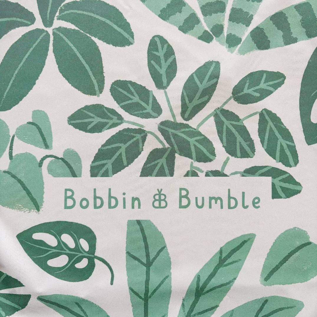 Splashmat with green leaf pattern and 'Bobbin & Bumble' branding on a white background