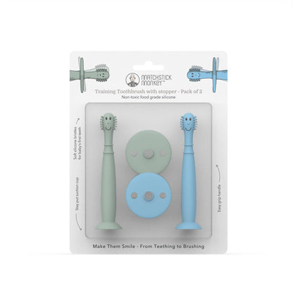Packaging of Matchstick Monkey training toothbrushes with stoppers in green and blue on a white background.