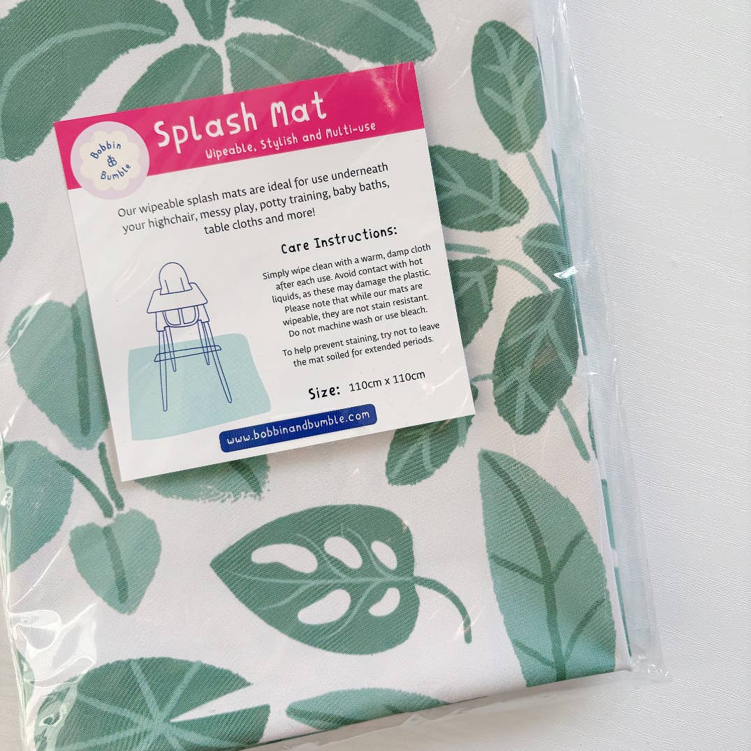 Wipeable splash mat with leaf pattern and packaging on a white background