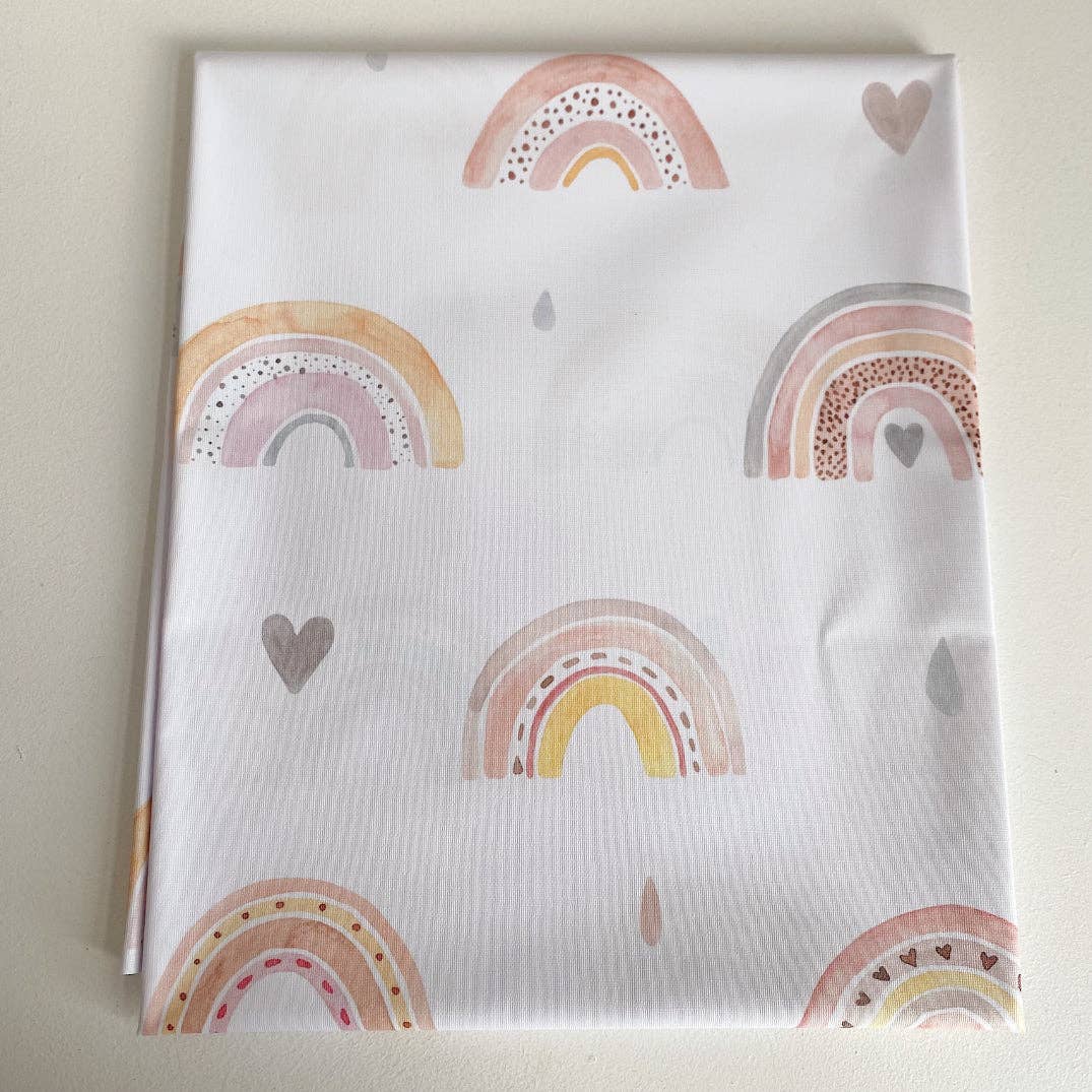 Splashmat with rainbow and heart patterns on a light background