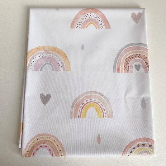 Splashmat with rainbow and heart patterns on a light background