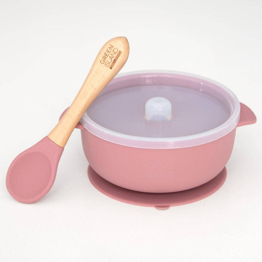 Pink baby bowl with lid and wooden spoon on a white background