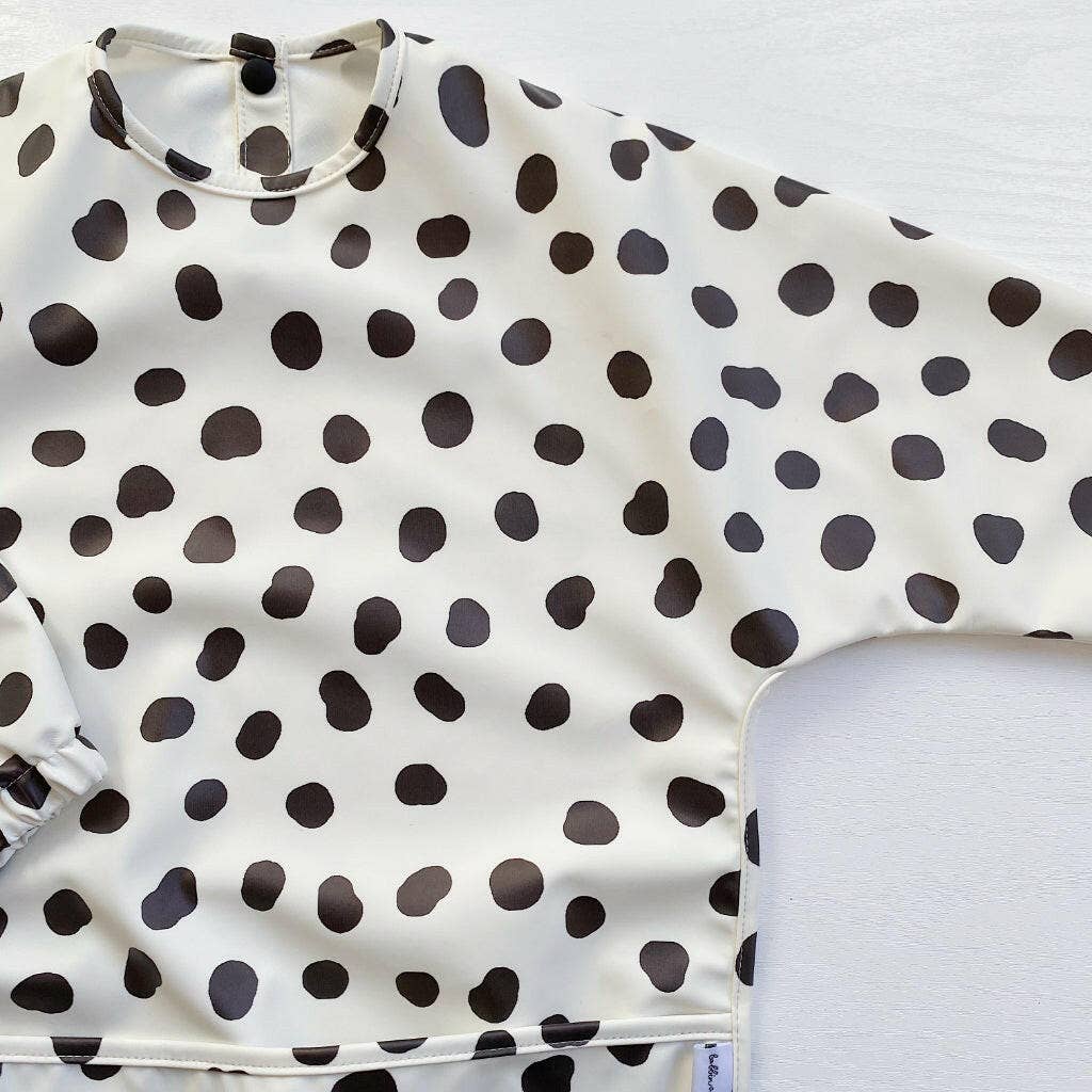 Polka dot bib with black dots on a white background