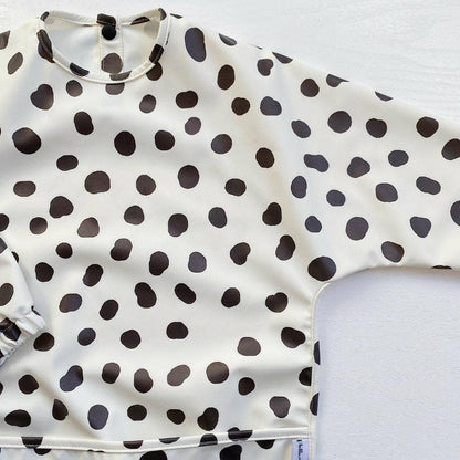 Polka dot bib with black dots on a white background