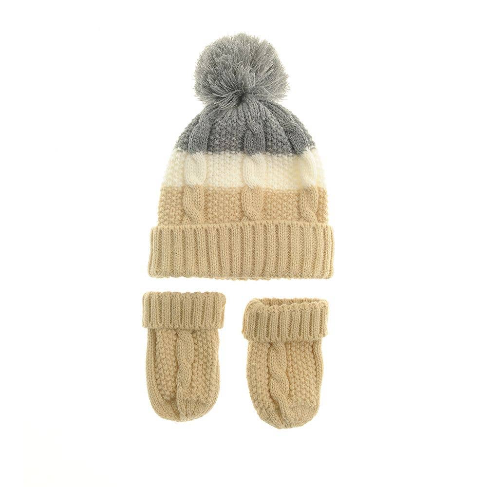 Knitted hat with pom-pom and matching mittens on a white background