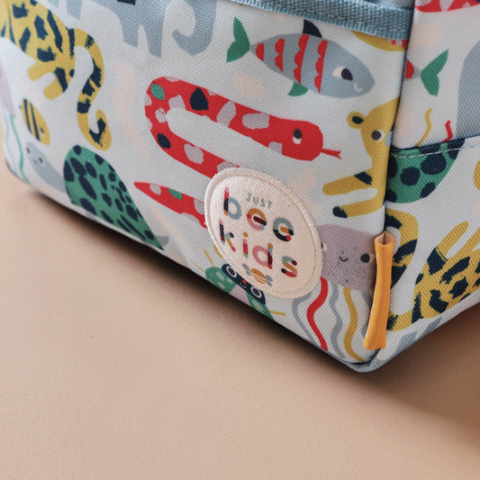 Children's pouch with animal pattern and 'bee kids' label on a beige background