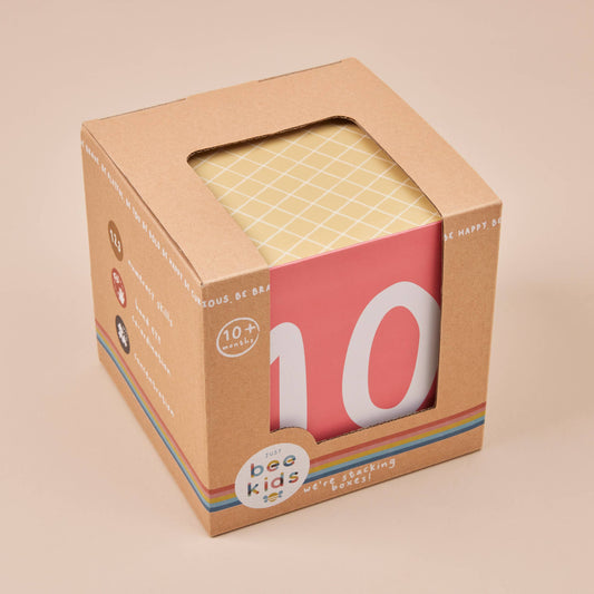 Boxed product with a colorful label on a beige background