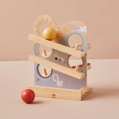 Wooden toy with colorful balls on a beige background