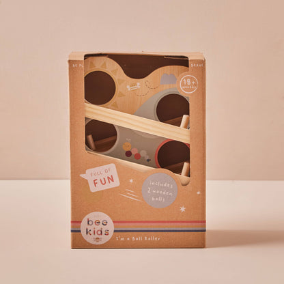 Wooden ball roller toy packaging with 'bee kids' branding on a beige background