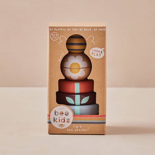 Stack of colorful wooden toys with 'bee kids' branding on a beige background