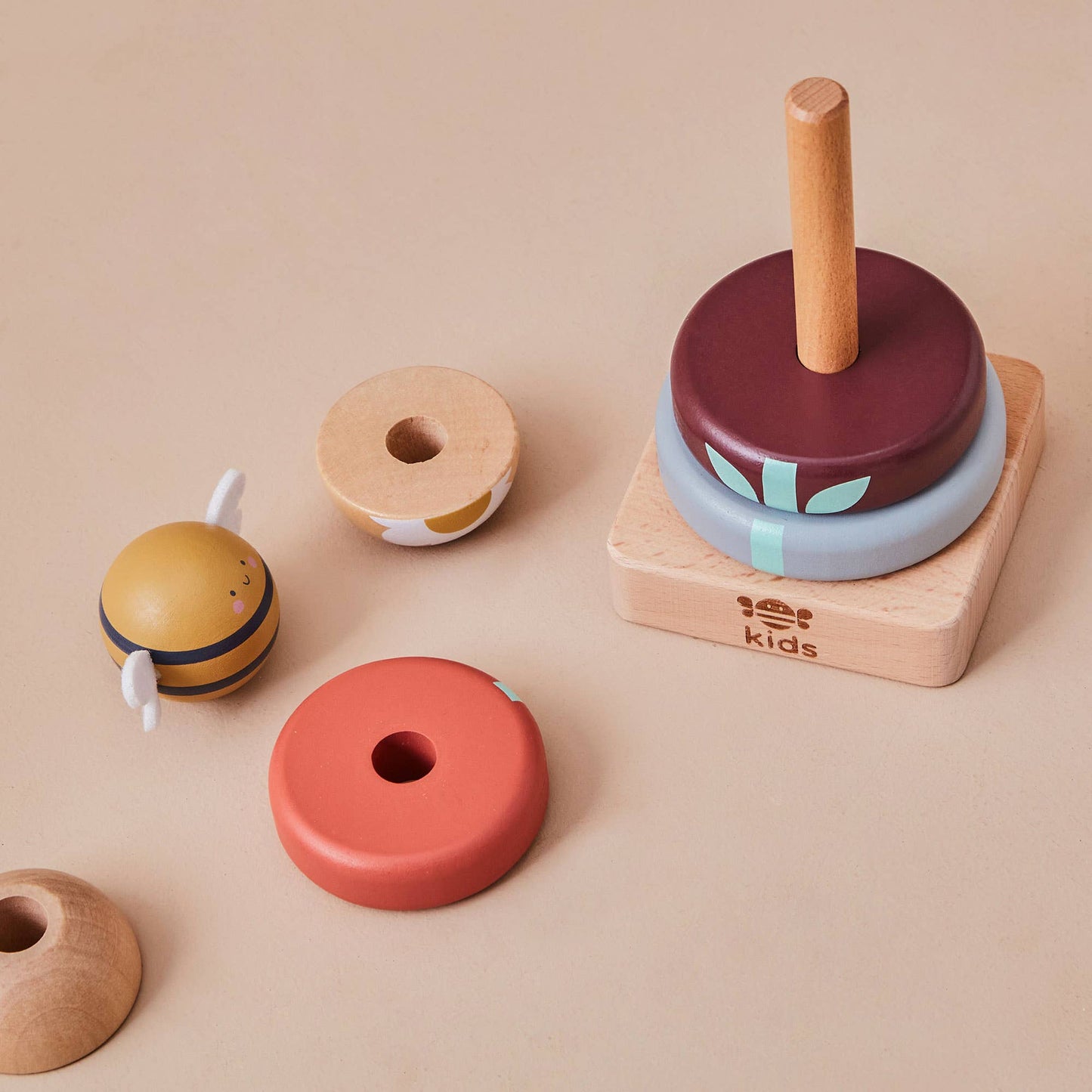 Set of colorful wooden toys on a beige background
