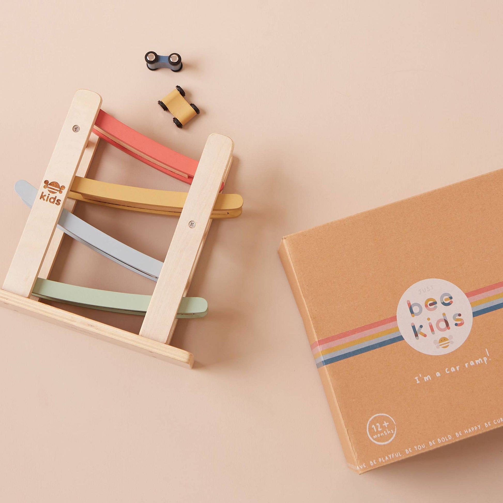 Colorful wooden toy ladder with 'bee kids' branding on a beige background