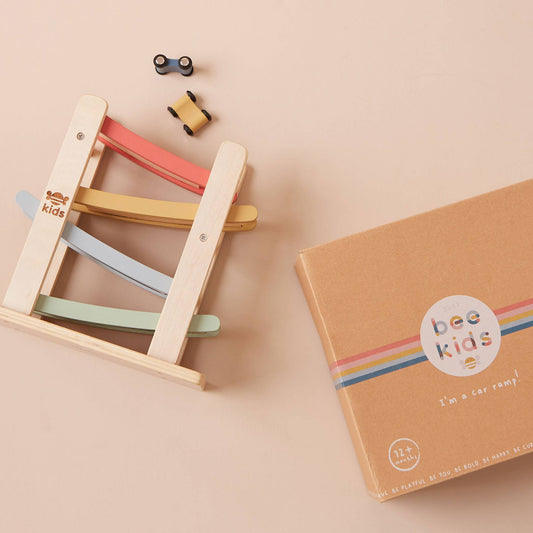 Colorful wooden toy ladder with 'bee kids' branding on a beige background