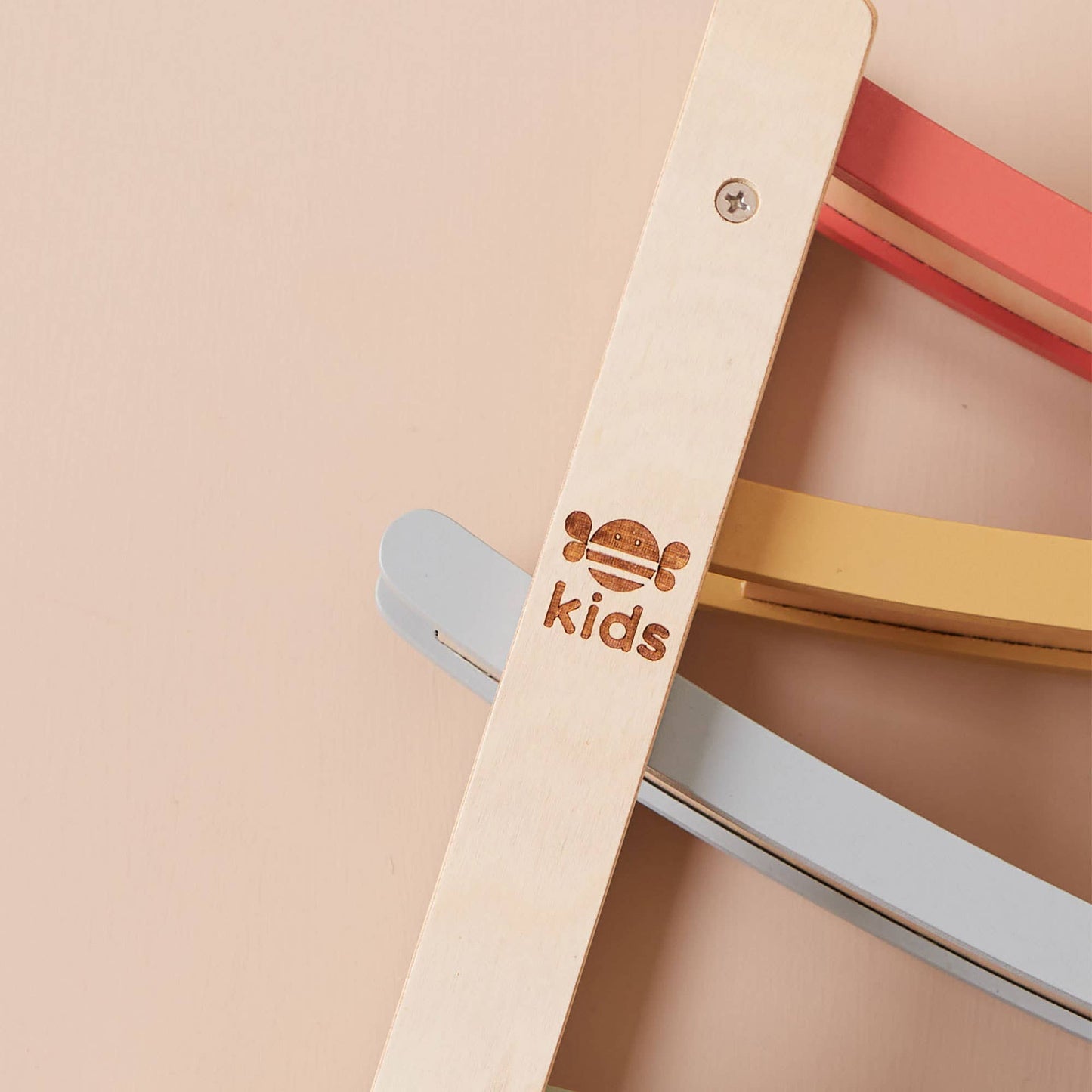 Children's chair with colorful seat and backrest on a beige background