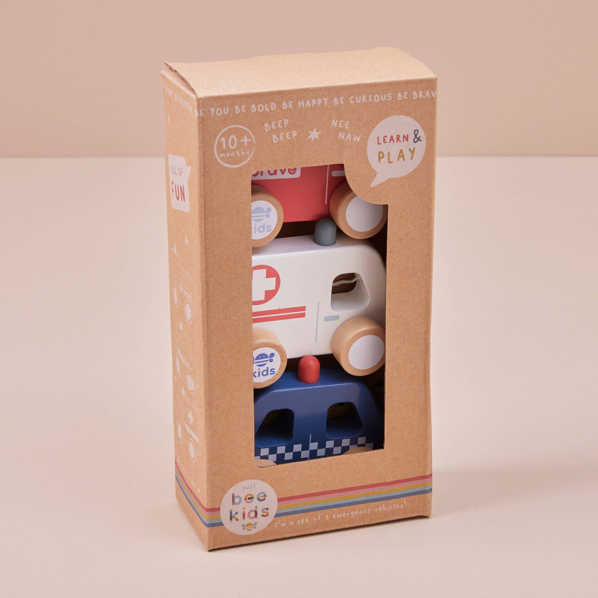 Box of wooden toy cars with visible branding on a beige background