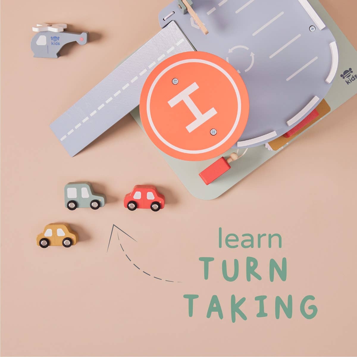 Toy road mat with cars and a helicopter on a beige background, featuring text 'learn TURN TAKING'.