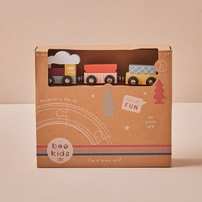 Box of toy train set with 'bee kids' branding on a beige background