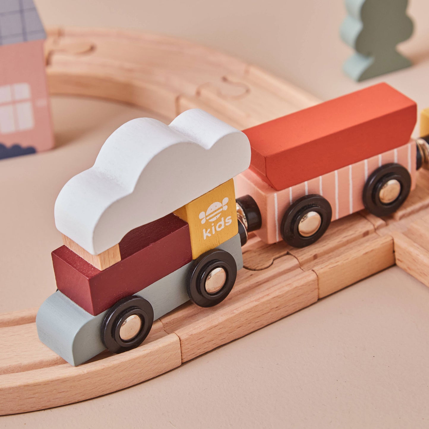 Wooden toy train with colorful cars on a wooden track