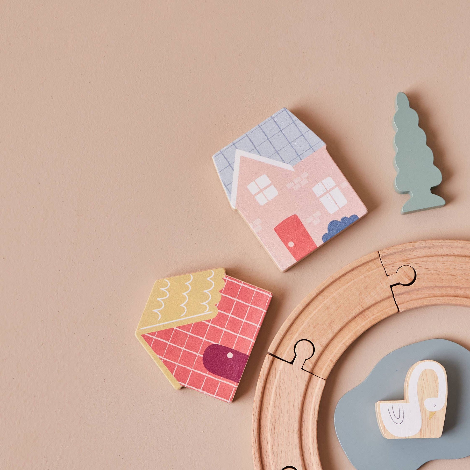 Wooden toy houses and a puzzle on a beige background