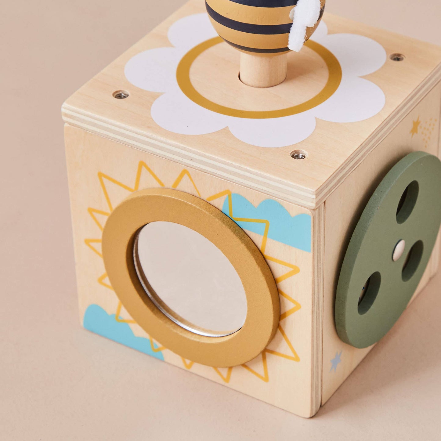 Wooden toy box with geometric shapes and patterns on a beige background