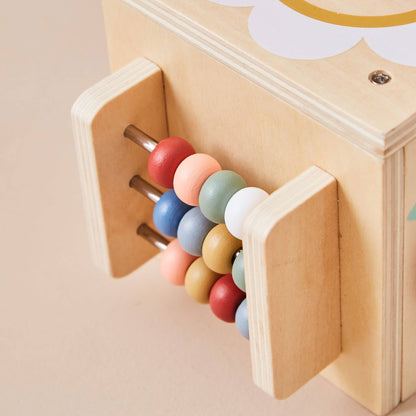 Wooden toy with colourful beads inside a compartment