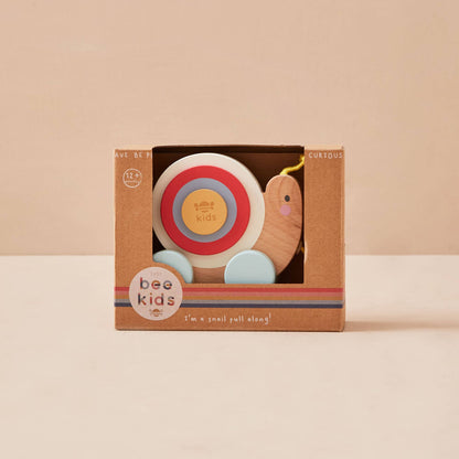 Wooden toy with a target design in a 'bee kids' branded box on a beige background