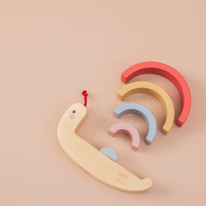 Set of colorful wooden toys shaped like arches on a beige background