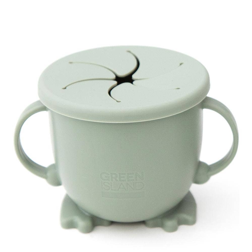 Green children's cup with lid and suction cup on a white background