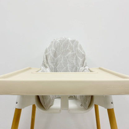 High chair with a white cushion cover on a plain background