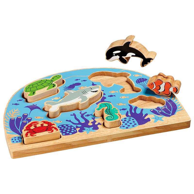Wooden puzzle with sea animal figures on a colorful underwater-themed base