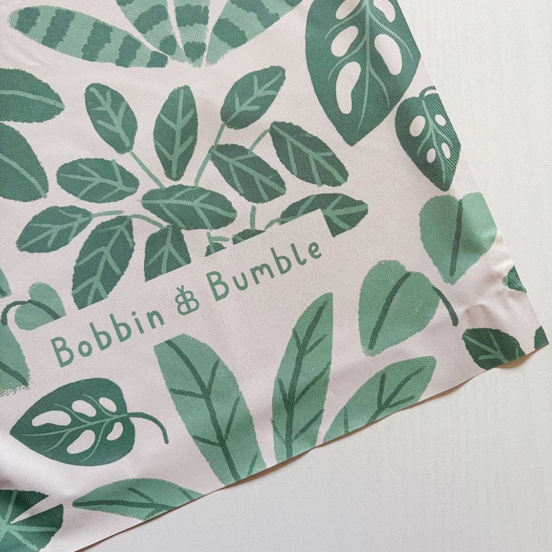 Splashmat with green leaf pattern and 'Bobbin & Bumble' branding on a light background