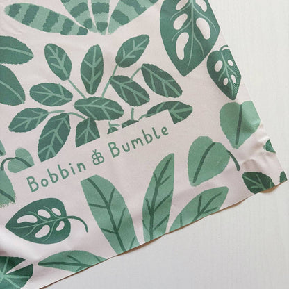 Splashmat with green leaf pattern and 'Bobbin & Bumble' branding on a light background