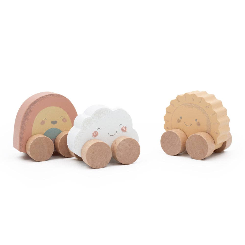 Three wooden toys shaped like a cloud, a sun, and a rainbow with faces on a white background