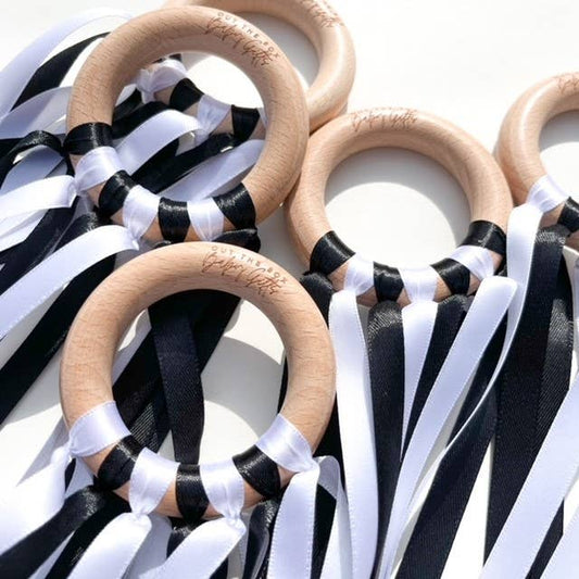 Wooden rings with black and white ribbons on a white background